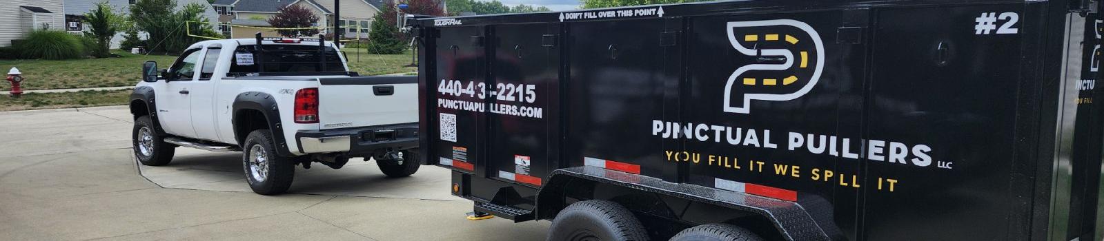 dumpster trailer in drive with pickup attached