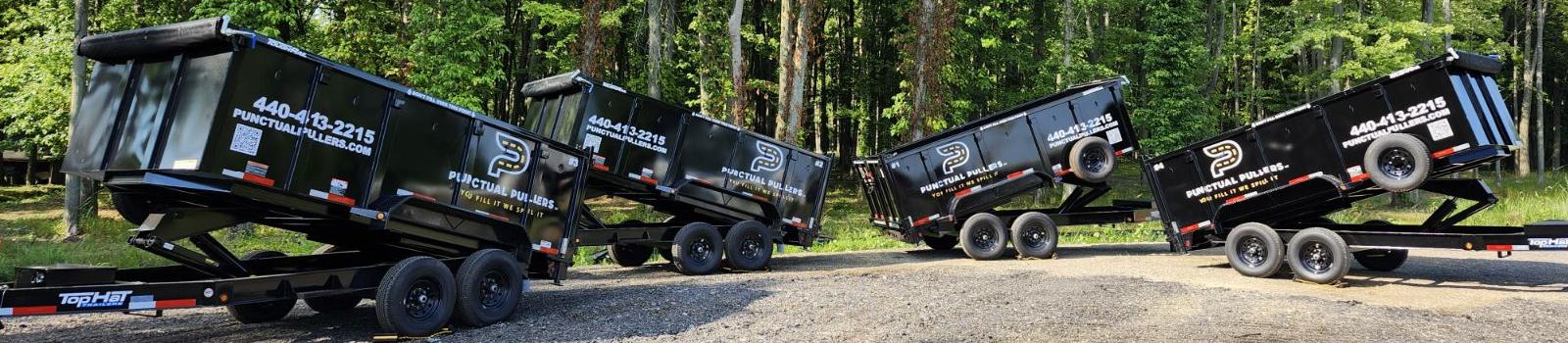 four dump trailers lined up 