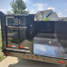 back of dumpster trailer with one door open